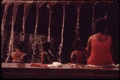 People cooling off beside a fountain at the Philadelphia Museum of Art