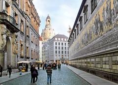 Dresden's Augustusstraße showcasing the Fürstenzug mural and Frauenkirche in the background