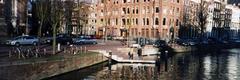 Homomonument in Amsterdam, pink granite triangle on a canal