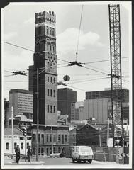 Museum Station under construction in Melbourne City Loop, July 1974, with Coop's Shot Tower visible in the background.