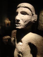 Stone sculpture of a man in the Museum of Pre-Columbian Art in Santiago, Chile