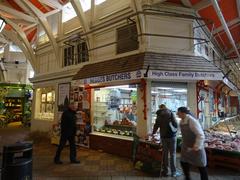 Butcher's shop in an indoor market with meat products on display