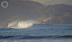 surfing at San Juan beach in Asturias, Spain