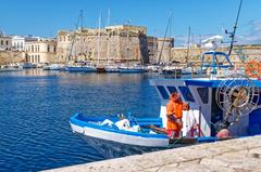 Panoramic view of the Port of Gallipoli with clear blue waters and historic buildings