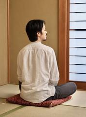 Dr. MINAMOTO Takahito practicing Zen meditation in a Japanese-style room