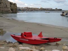 monument on the beach near the sea wall in Otranto, Italy, part of cultural heritage