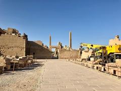 Karnak Temple complex at Luxor in Egypt with ancient ruins and towering columns under a deep blue sky