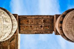 Colourful Egyptian hieroglyphic symbols carved on the stone pillars