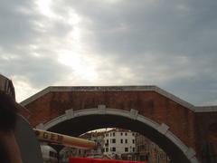 Venice canal bridge with boats and historic buildings