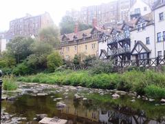 Dean Village in Edinburgh with traditional stone buildings and the Water of Leith