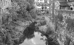 Dean Village in Edinburgh with historic buildings and a lush riverbank