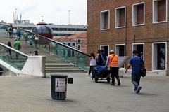 porter carrying luggage on Calatrava's bridge in Venice