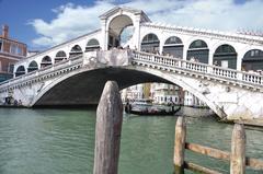 Grand Canal in Venice with gondolas and Rialto Bridge