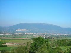 Mount Subasio in Assisi with lush greenery under a blue sky