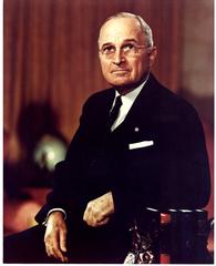 Color portrait of President Harry S. Truman seated in a chair