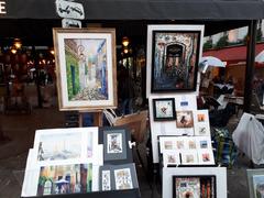 Montmartre exhibition showcasing various artworks with visitors browsing