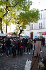 Place du Tertre in Paris, France, with artists, cafés, and pedestrians