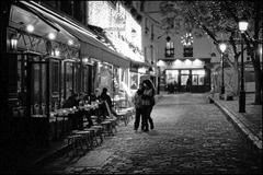 Place du Tertre bustling with people, cafes, and artists in Montmartre, Paris