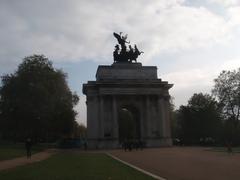 Hyde Park in London with green lawns and trees under a clear sky