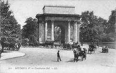 Hyde Park Corner in 1904 showing the Constitution Arch and Constitution Hill with a solitary figure in foreground