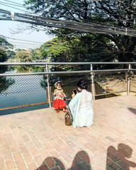 Person capturing a tender moment by the lake in Dhaka