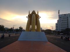 Dragon Bridge at dusk with dragon statues on both sides and city lights illuminating the bridge and surrounding area