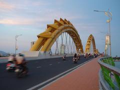 Dragon Bridge lit up at night with dragon sculptures