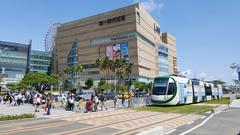 Uni-President Hankyu Department Store in Kaohsiung with a light rail train