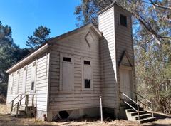 Historic schoolhouse on Angel Island, surrounded by greenery and hills