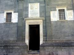 Engravings on the entrance door of the lateral facade of the Pontano Chapel in Naples