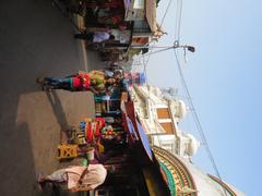 Kolkata street view featuring people, vehicles, and buildings