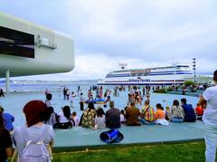 Exterior square of the Botín Center in the Pereda Gardens of Santander with a Brittany Ferries ferry in the background