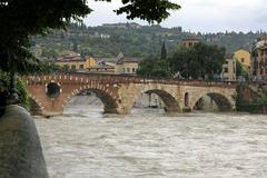 Ponte Pietra bridge with high water levels as seen from Piazzetta Brà Molinari