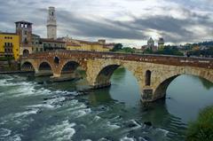 Roman arch bridge Ponte Pietra crossing Adige River in Verona