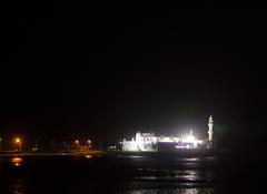 Haji Ali Dargah with surrounding water and distant Mumbai skyline