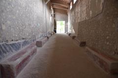 Corridor linking different parts of Villa Poppaea with red painted benches along the walls