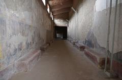 Corridor with red benches in Villa Poppaea, Italy