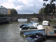 Boats moored below Folly Bridge on a calm day