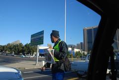 newspaper vendor selling papers in the street in Cape Town