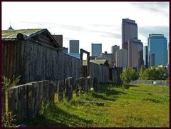 Junction of Elbow and Bow Rivers with restored Fort buildings and Calgary skyline