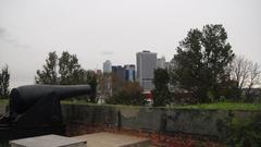 a panoramic view of Governors Island with Fort Jay in the foreground and the Manhattan skyline in the background