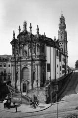 Historic street in Porto, Portugal with vintage cars and pedestrians