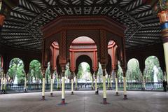 Interior view of Kiosco Morisco showcasing intricate ironwork and vibrant stained glass windows