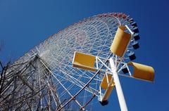 Ferris wheel in an amusement park with a blue sky background