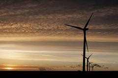 sunset with windmills generating renewable energy