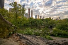 View of Gapstow Bridge and pond in Central Park with distant construction cranes