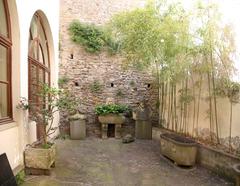 Casa Museo Ivan Bruschi courtyard with ancient stone artifacts