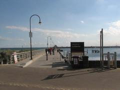 St Kilda Pier during sunset with calm water and a partly cloudy sky