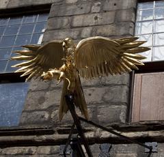 Gladstone's Land Golden Hawk sculpture on a city building facade