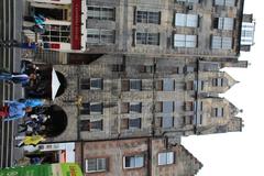 Historic multi-story building with a separate servants' entrance, located on Lawnmarket in Edinburgh